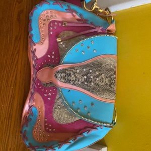 Multi color purse worh handle. Ink spot  inside